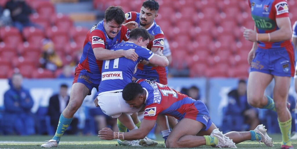 Jets backrower Kyle Pickering is well contained here by these Newcastle Knights defenders. Photo: NRL Imagery
 
