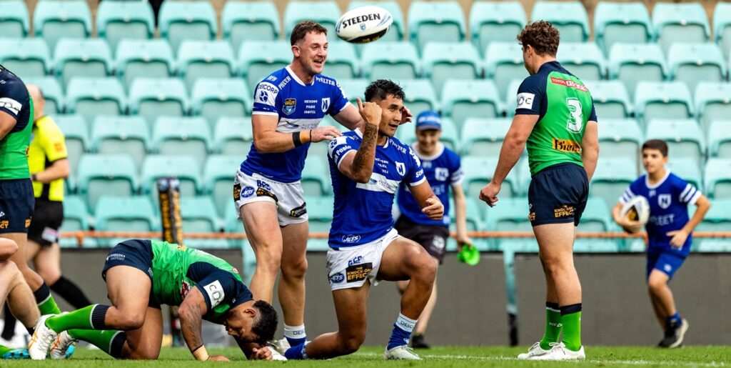 Jets centre Chris Vea'ila (in front) celebrates scoring Newtown's first try, along with backrower Kyle Pickering (standing). Photo: Mario Facchini, mafphotography