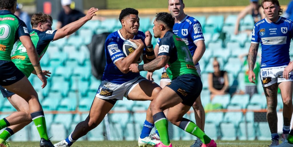 Newtown middle forward Tuku Hau Tapuha presents a fearsome prospect for these Raiders defenders. Photo: Mario Facchini/mafphotography